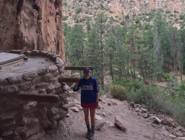 Megan by an old Pueblo house