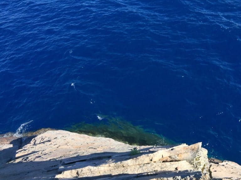 A top-of-cliff vantage point from a spot where you can hop into the deep blue water!